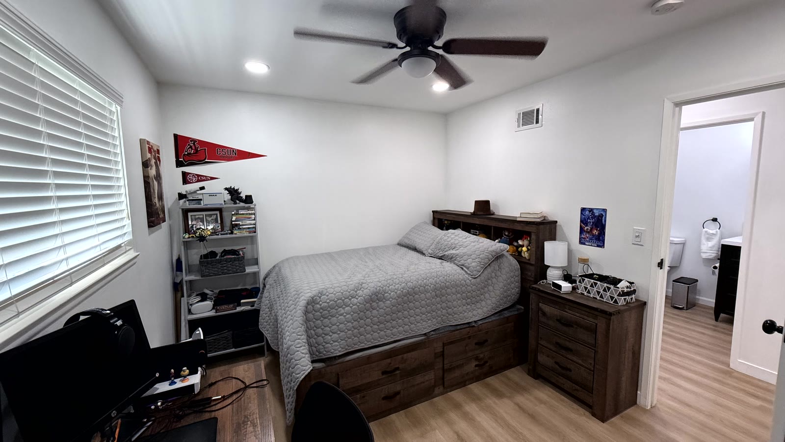 Fourth bedroom with white walls, a ceiling fan plus recessed lighting, a window with white horizontal blinds and wood-look plank flooring.
